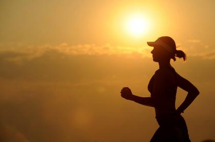 Silhouetted person jogging outside