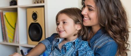 Woman and daughter using computer together