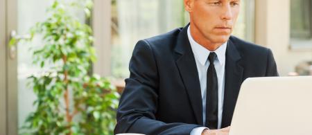 Professional businessman works on laptop