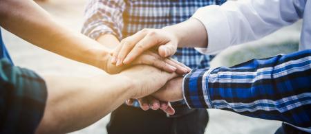 Group of young professional hands together in a circle