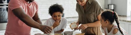 family of four making breakfast