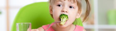 little girl eating healthy food