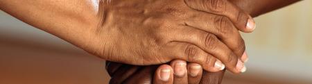 Close up of adults grasping hands