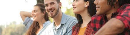 A group of four young adults in a park