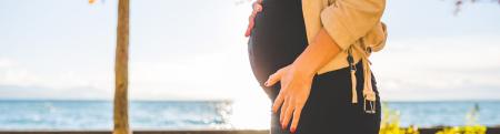 Pregnant woman outside near a lake