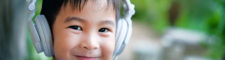 A smiling toddler using headphones