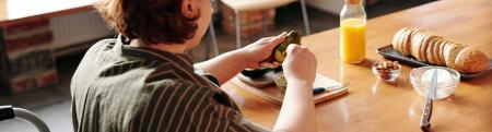 Adult in a wheelchair prepares a meal at a table