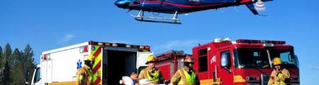 First responders and their vehicles including an ambulance, firetruck, and helicopter