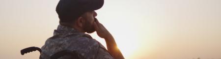 veteran in a wheelchair overlooking the sunset.