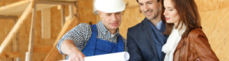 Young couple looking at house plans with their contractor