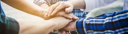 Group of young professional hands together in a circle