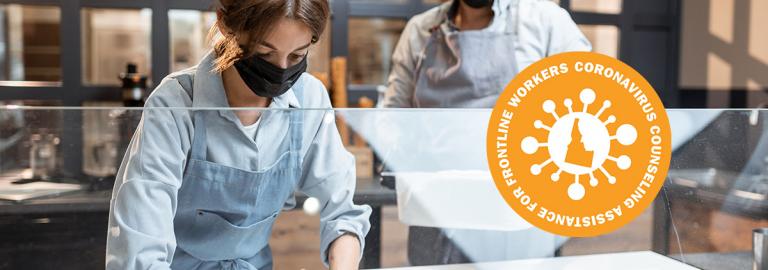 Masked workers cleaning equipment.