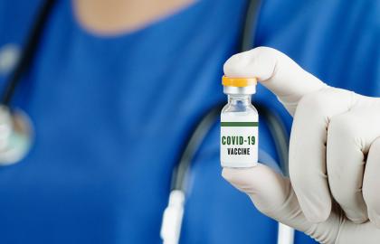 Nurse holding a bottle of COVID-19 vaccine