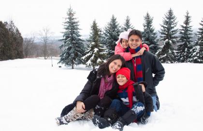 Happy family sitting in a snowy forest