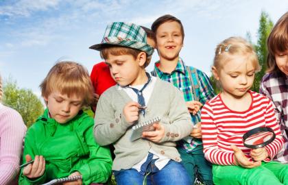 A group of children looking through magnifying glasses