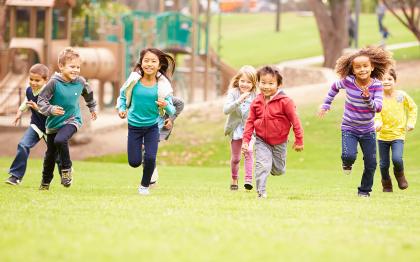 Group of kids running at a playground