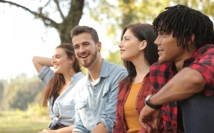 A group of four young adults in a park