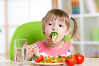 little girl eating healthy food
