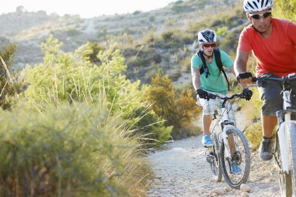 Two men bicycling on a desert trail