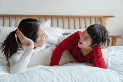 An adult and child laughing together