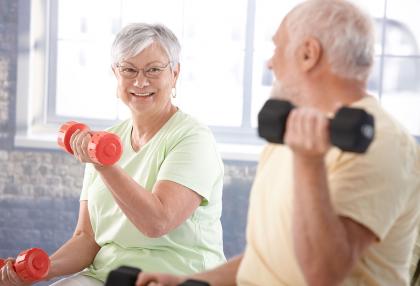 An older couple using weights to workout