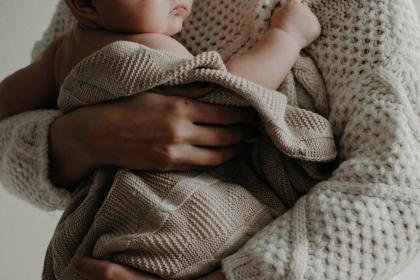 Infant being cuddled in a blanket