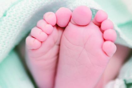 A close up of new born baby feet