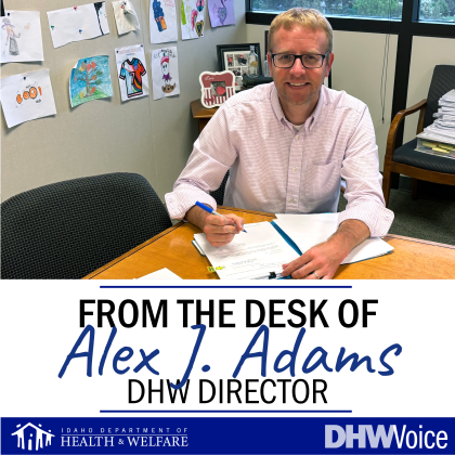 DHW Director Alex J. Adams signing 250th adoption 